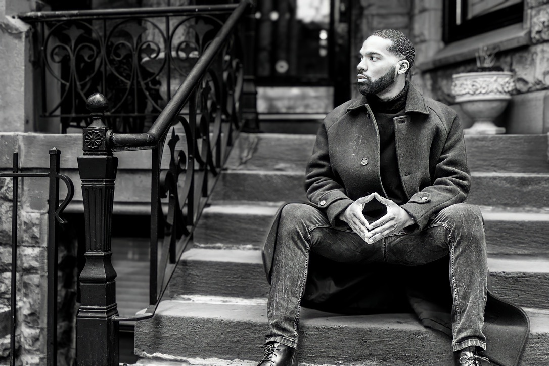 Black and white menswear portrait seated on stone steps