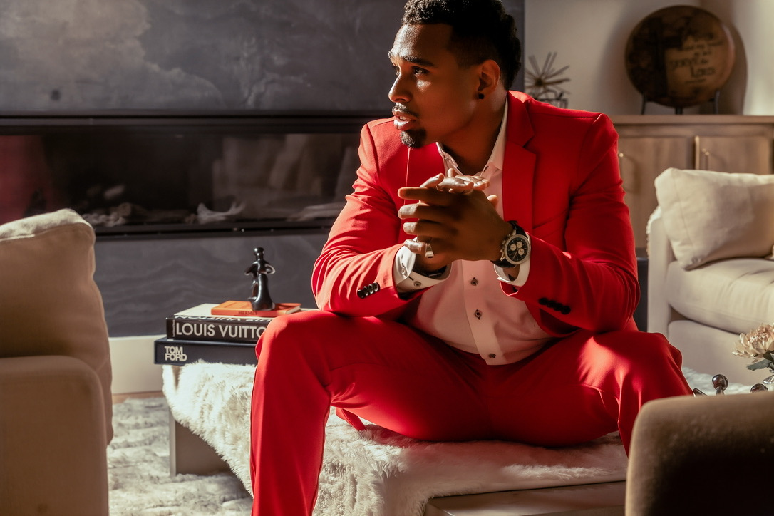 Portrait in a red suit, seated in window light
